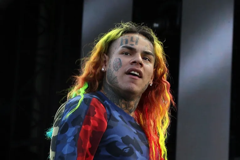 man with colorful hair on stage