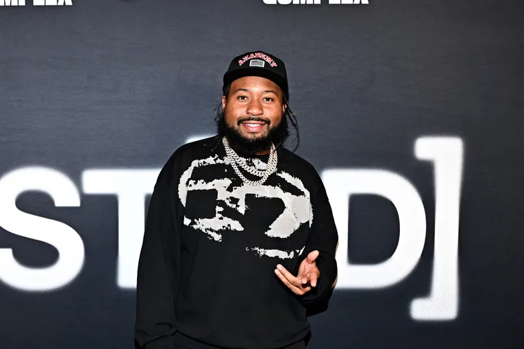 man posing in front of backdrop