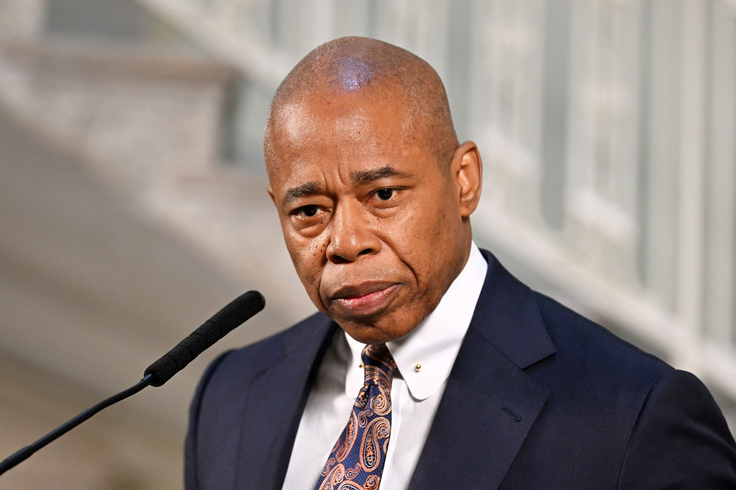 man posing at podium