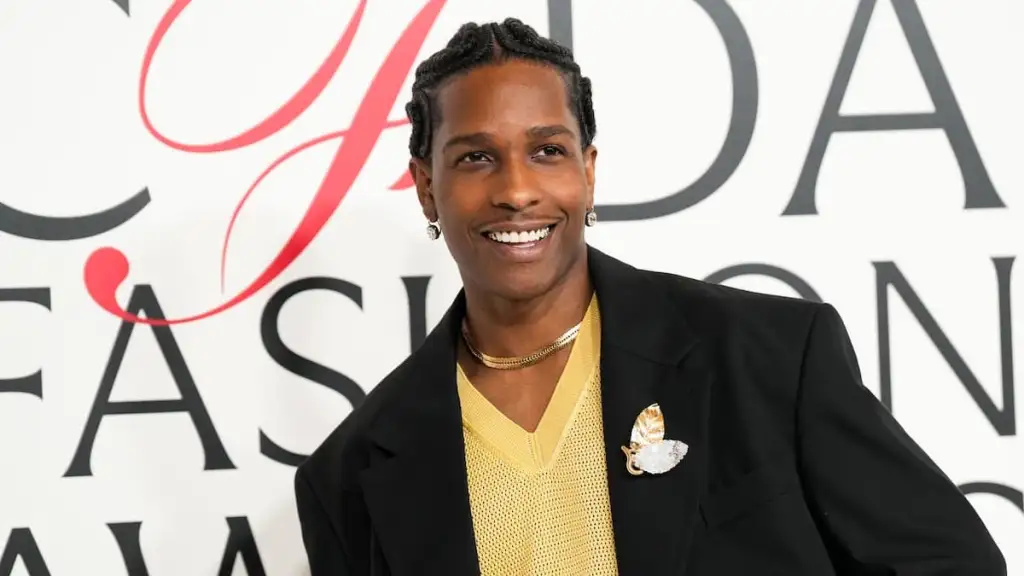 man standing against back drop